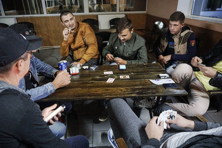 Männer in einer Kneipe. Eigentlich wollen alle weg. Foto: Éric Vazzoler